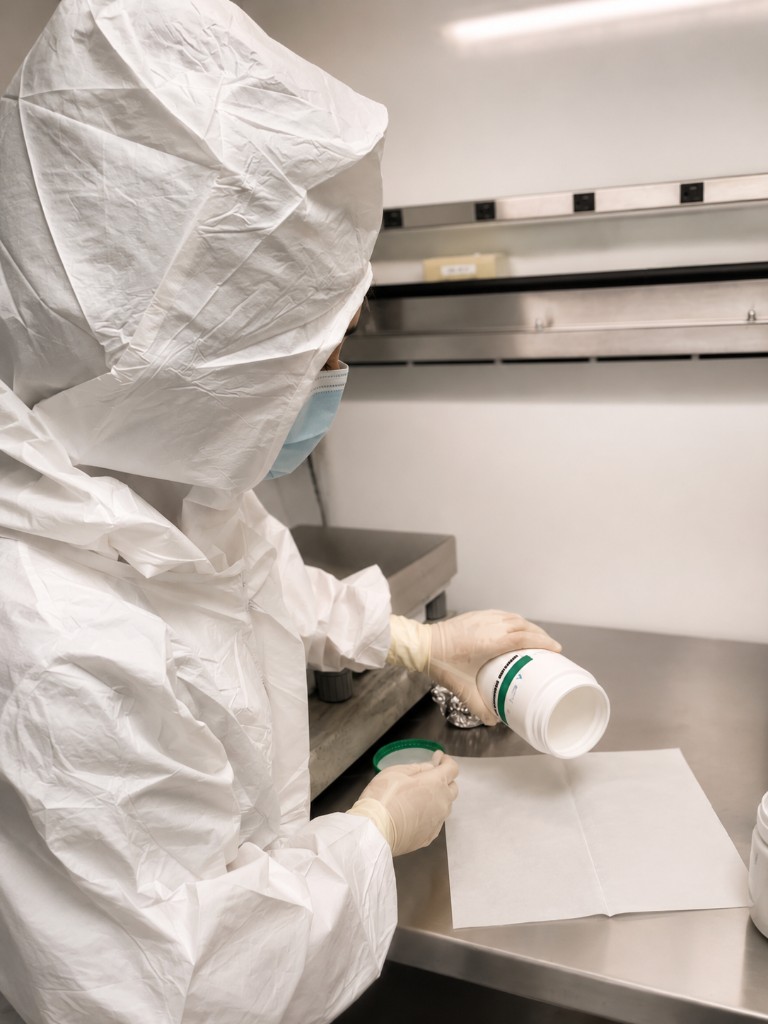 Pharmacist compounding in a sterile cleanroom